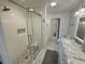Bright bathroom featuring a tiled shower with a glass door and a marble countertop vanity at 81 Sandbar Ln # 28, Folly Beach, SC 29439