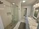 Bright bathroom featuring a tiled shower with a glass door and a marble countertop vanity at 81 Sandbar Ln # 28, Folly Beach, SC 29439