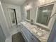 Bright bathroom featuring dual sinks and a marble countertop vanity at 81 Sandbar Ln # 28, Folly Beach, SC 29439