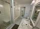 Bright bathroom featuring a tiled shower and tub with a marble countertop vanity and elegant lighting at 81 Sandbar Ln # 28, Folly Beach, SC 29439
