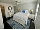 Cozy bedroom with white furniture, ceiling fan, and blue accent rug at 81 Sandbar Ln # 28, Folly Beach, SC 29439