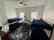 Bright bedroom with two sets of bunk beds, ceiling fan, windows, and a cozy gray beanbag at 81 Sandbar Ln # 28, Folly Beach, SC 29439