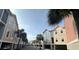 Street view of charming townhomes with colorful exteriors and palm trees, creating a vibrant and inviting community atmosphere at 81 Sandbar Ln # 28, Folly Beach, SC 29439