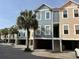 Colorful townhome exterior, showcasing coastal design, multiple stories, and outdoor parking at 81 Sandbar Ln # 28, Folly Beach, SC 29439