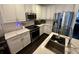 Modern kitchen featuring white cabinetry, stainless steel appliances, subway tile backsplash, and a large island with counter seating at 81 Sandbar Ln # 28, Folly Beach, SC 29439