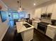 Stylish kitchen featuring an island, stainless steel appliances, white cabinets and open layout to the living room and dining area at 81 Sandbar Ln # 28, Folly Beach, SC 29439
