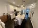 Bright and stylish kitchen with white cabinets, stainless steel appliances, a center island, and open to dining area and staircase at 81 Sandbar Ln # 28, Folly Beach, SC 29439
