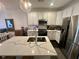 Modern kitchen featuring white cabinetry, stainless steel appliances, subway tile backsplash, and a large island with a marble countertop at 81 Sandbar Ln # 28, Folly Beach, SC 29439