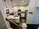 Modern kitchen featuring white cabinetry, stainless steel appliances, subway tile backsplash, and a large island with counter seating at 81 Sandbar Ln # 28, Folly Beach, SC 29439