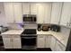Bright kitchen features white cabinets, stainless steel appliances, and stylish subway tile backsplash at 81 Sandbar Ln # 28, Folly Beach, SC 29439
