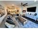 Spacious living room with modern furnishings, TV, and decor, flowing into kitchen and dining areas at 81 Sandbar Ln # 28, Folly Beach, SC 29439