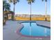 Beautiful pool featuring a brick border and scenic view of water and pier in the distance at 81 Sandbar Ln # 28, Folly Beach, SC 29439