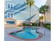 Inviting pool area surrounded by palm trees and building exterior, a great spot to relax at 81 Sandbar Ln # 28, Folly Beach, SC 29439