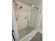 Bright shower featuring a tiled shower with a glass door and seat at 81 Sandbar Ln # 28, Folly Beach, SC 29439