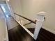 Modern staircase with sleek metal cable railing and hardwood steps at 81 Sandbar Ln # 28, Folly Beach, SC 29439