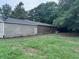 Shows the back of the property with grass, trees, and a shed at 838 Ranch Hill Ln, Saint Stephen, SC 29479