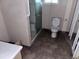 The bathroom has tiled floor, glass shower, and a toilet at 838 Ranch Hill Ln, Saint Stephen, SC 29479