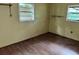 The bedroom has laminate wood flooring and two windows for natural light at 838 Ranch Hill Ln, Saint Stephen, SC 29479