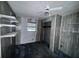This bedroom has wood paneled walls, a ceiling fan, and white shelves at 838 Ranch Hill Ln, Saint Stephen, SC 29479
