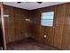 This bedroom has wood paneled walls and a window to let in light at 838 Ranch Hill Ln, Saint Stephen, SC 29479
