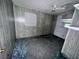 This bedroom has wood paneled walls, a ceiling fan, and a window to let in light at 838 Ranch Hill Ln, Saint Stephen, SC 29479
