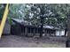 Single-story home's exterior featuring lots of windows and overgrown landscaping at 838 Ranch Hill Ln, Saint Stephen, SC 29479