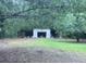 View of garage surrounded by lots of trees at 838 Ranch Hill Ln, Saint Stephen, SC 29479
