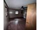 The living room has wood floor, wood paneling, and a ceiling fan at 838 Ranch Hill Ln, Saint Stephen, SC 29479