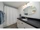 Bathroom features a white vanity with black countertop and a shower with a decorative curtain at 855 Club Cottage Rd, Edisto Island, SC 29438