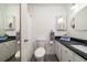 Well-lit bathroom with dual vanities, granite countertops, and a walk-in shower with decorative mirror at 855 Club Cottage Rd, Edisto Island, SC 29438