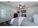 Serene bedroom featuring a ceiling fan, sliding doors to porch, and cozy decor elements at 855 Club Cottage Rd, Edisto Island, SC 29438