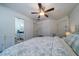 Bright bedroom featuring wood floors and glimpses into the adjacent bathroom and access to closets at 855 Club Cottage Rd, Edisto Island, SC 29438