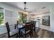 Dining area with a table set for six, leading to a modern kitchen at 855 Club Cottage Rd, Edisto Island, SC 29438