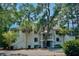 Multi-Gathering residence surrounded by lush greenery and mature trees at 855 Club Cottage Rd, Edisto Island, SC 29438