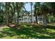 Three-story condo complex nestled among lush green trees on a well maintained lawn at 855 Club Cottage Rd, Edisto Island, SC 29438