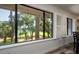 Large windows showcase picturesque golf course views at 855 Club Cottage Rd, Edisto Island, SC 29438