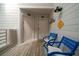 Inviting hallway featuring blue and white seating, leading to cozy and private guest rooms at 855 Club Cottage Rd, Edisto Island, SC 29438