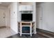Cozy living room corner with electric fireplace, TV, and custom corner cabinets and open shelving at 855 Club Cottage Rd, Edisto Island, SC 29438