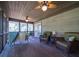 Inviting screened porch with ceiling fans and stylish furniture, perfect for outdoor enjoyment at 855 Club Cottage Rd, Edisto Island, SC 29438