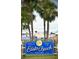 Bright blue sign welcomes you to Edisto Beach, a Gathering tradition established in 1970, surrounded by palm trees at 855 Club Cottage Rd, Edisto Island, SC 29438