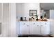 Elegant wet bar featuring white cabinetry, stylish decor, and a convenient sink for entertaining guests at 855 Club Cottage Rd, Edisto Island, SC 29438