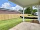 View of the backyard featuring a concrete patio, a wood fence, and green grass at 8629 Connor Ct, North Charleston, SC 29406