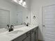 Well-lit bathroom showcases a white countertop vanity with gray cabinets and black fixtures at 8629 Connor Ct, North Charleston, SC 29406