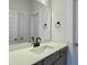 Modern bathroom features a white countertop vanity with black fixtures and a large mirror at 8629 Connor Ct, North Charleston, SC 29406