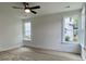 Bright bedroom with two large windows, neutral walls, and a ceiling fan at 8629 Connor Ct, North Charleston, SC 29406