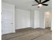 Large bedroom with neutral walls, a ceiling fan, a closet door, and two electrical outlets at 8629 Connor Ct, North Charleston, SC 29406