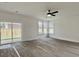 Spacious bedroom with a ceiling fan, multiple windows, and sliding glass door to back patio at 8629 Connor Ct, North Charleston, SC 29406