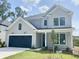 Charming two-story home with gray siding, black garage door, and well-manicured lawn at 8629 Connor Ct, North Charleston, SC 29406