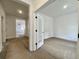Bright hallway view leading to an unfurnished room featuring a frosted glass door and neutral walls at 8629 Connor Ct, North Charleston, SC 29406