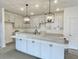 Modern kitchen with white cabinets, black hardware, a kitchen island, and pendant lighting at 8629 Connor Ct, North Charleston, SC 29406